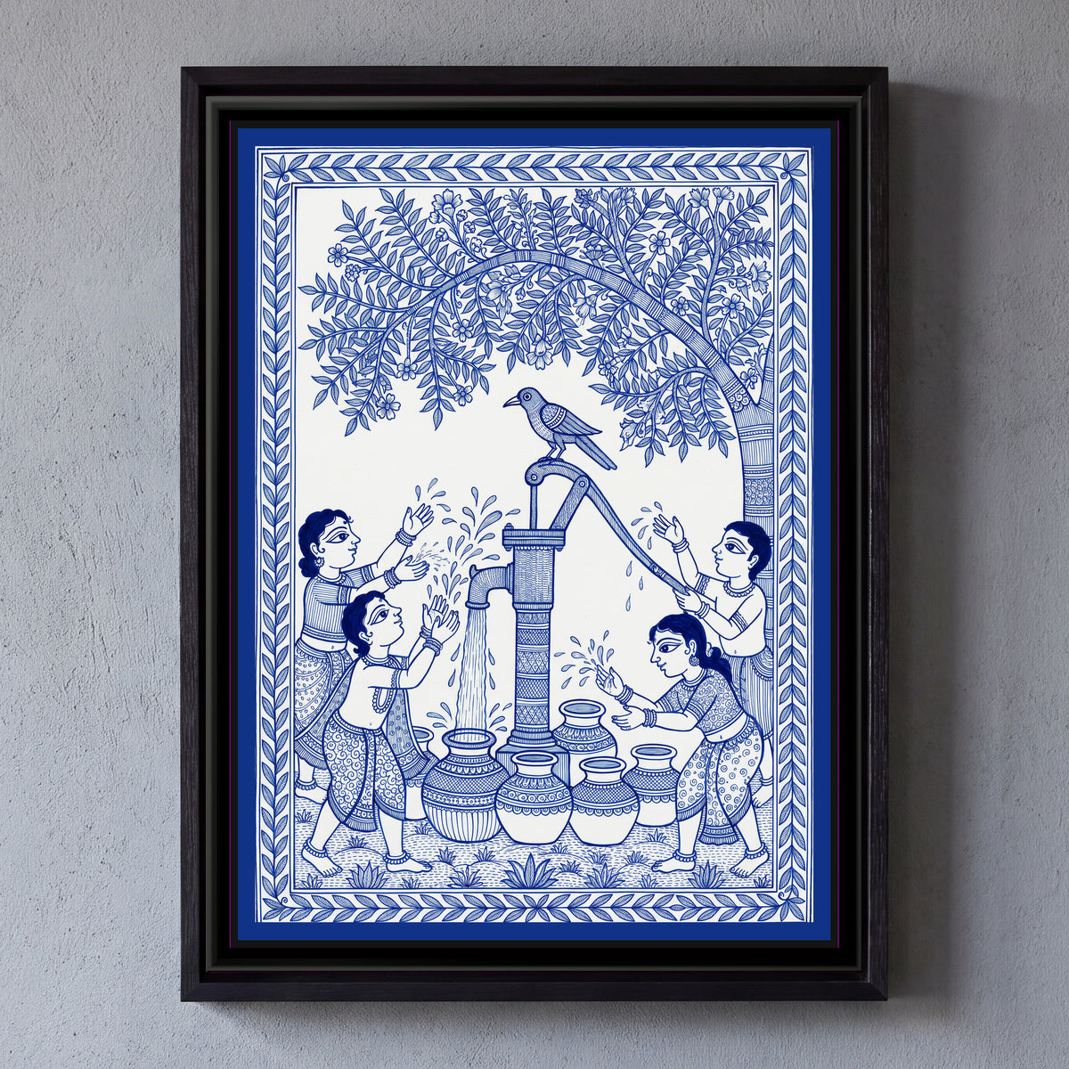 Madhubani Line Painting – The Hand Pump - framed canvas print of children splashing water at a village hand pump under a big tree, a crow on top, blue-and-white Madhubani line art, hung on a wall