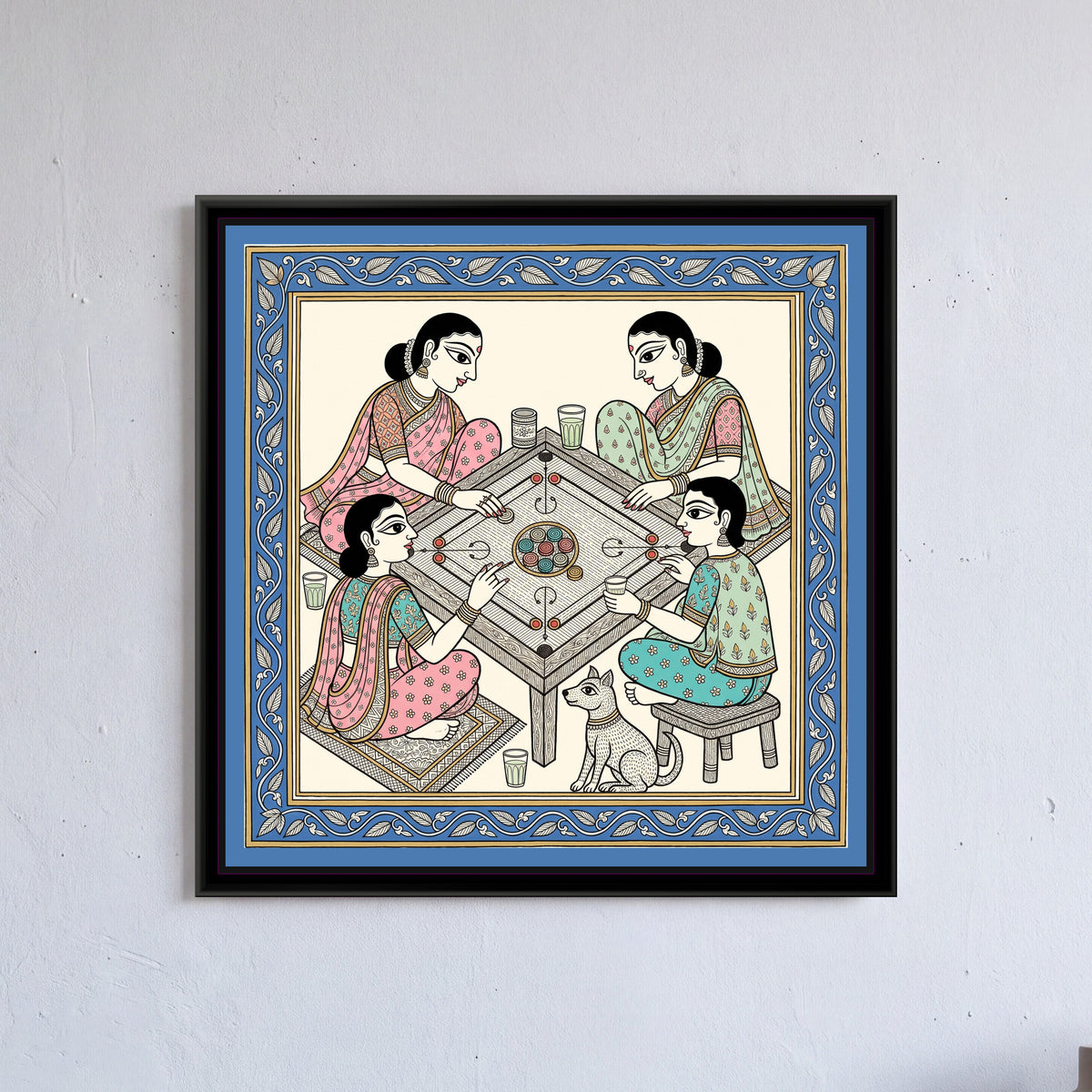 Chinoiserie Madhubani Painting – The Carrom Board - framed canvas print of four women friends playing carrom around a low table with a small dog beside them, Madhubani style in pink, mint and blue, hung on a wall
