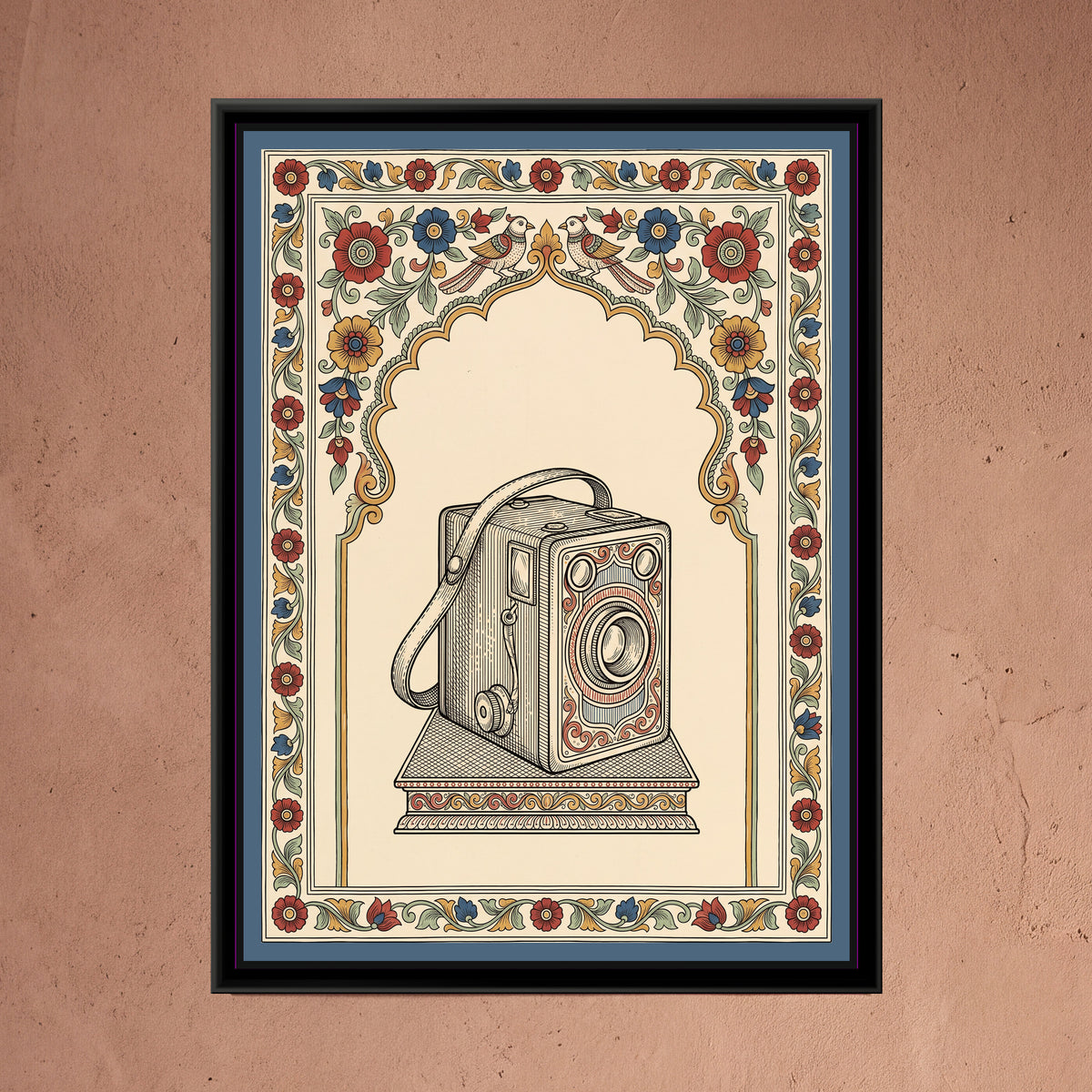 Kalamkari Painting – The Box Camera Portrait - framed canvas print of a vintage box camera with a leather carrying strap and a winding knob standing on a small patterned plinth, framed by a cusped arch of red, blue and ochre flowers with two parrots facing each other at the top, slate blue outer band, hung on a wall