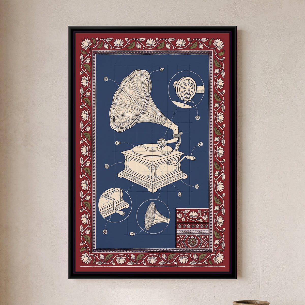 Kalamkari Blueprint – Gramophone - framed canvas print of a cream line drawing of a vintage gramophone on an indigo blueprint grid, with detail circles of the needle head, the winding crank and the horn, flower-tipped pointer lines, a small patterned swatch in one corner, deep red border of lotuses and leaves, hung on a wall