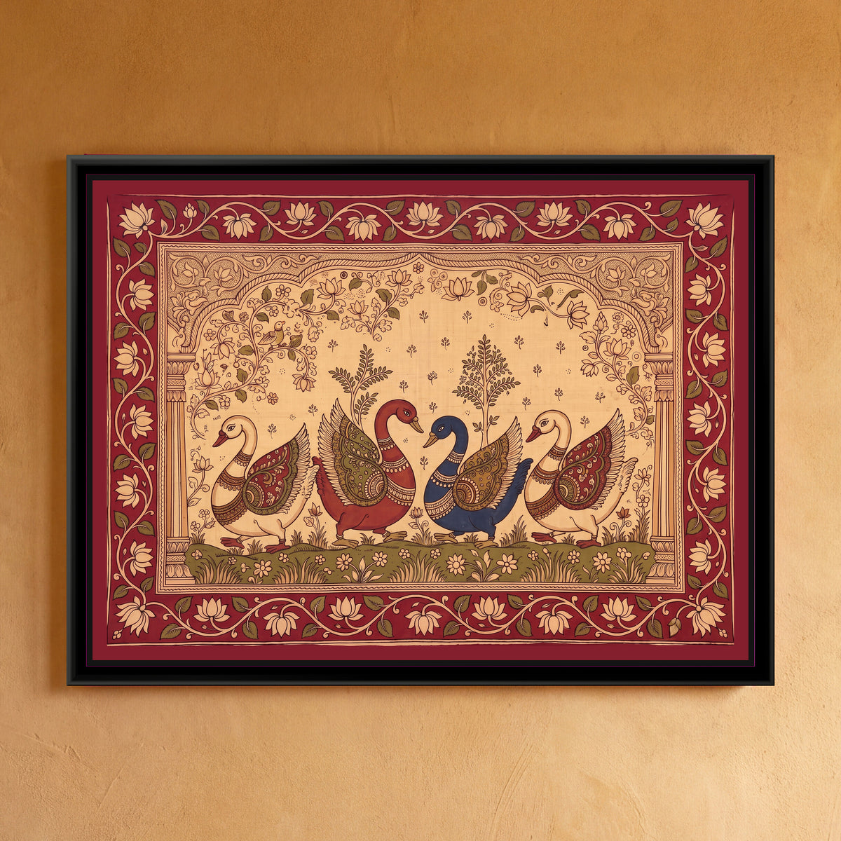 Kalamkari Painting – Procession of Swans - framed canvas print of four swans walking in a row across a green bank of small flowers, two cream swans on the outside and a red swan and an indigo swan meeting beak to beak in the middle, every wing filled with paisley and scroll patterns in red, olive and gold, two small leafy trees rising behind them, a cream ground with lotus vines under a carved arch on pillars, a deep red border of cream lotuses on a trailing vine, hung on a wall