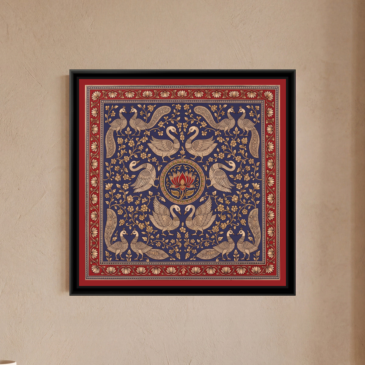 Kalamkari Painting – Swan Mandala – Indigo - framed canvas print of six cream line-drawn swans with finely patterned wings arranged in mirrored pairs around a round medallion holding a single red lotus, pairs of crested peacocks with long patterned tails in all four corners, cream flowering creepers filling a deep indigo blue ground, inside a madder red border of cream lotuses on a trailing vine, hung on a wall