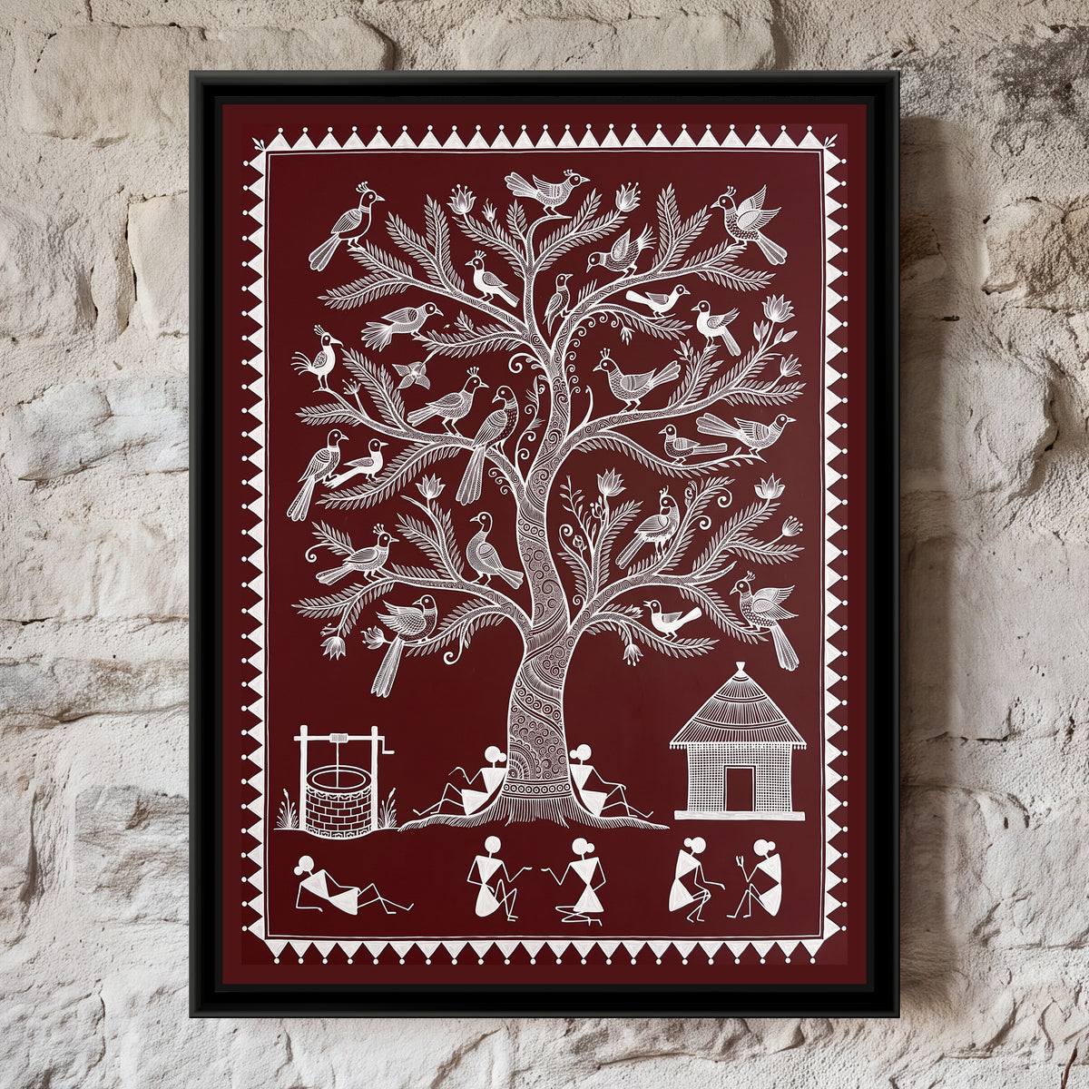 Warli Painting – Tree of Life with Birds – Deep Maroon - framed canvas print of a tall Warli tree of life with a spiral-patterned trunk and feathery branches holding around thirty crested birds and small lotus buds, two villagers leaning against the trunk, a brick well with a winch on the left, a thatched hut on the right and a row of stick-figure villagers chatting and resting below, white line on a deep maroon ground inside a border of white triangles and dots, hung on a wall