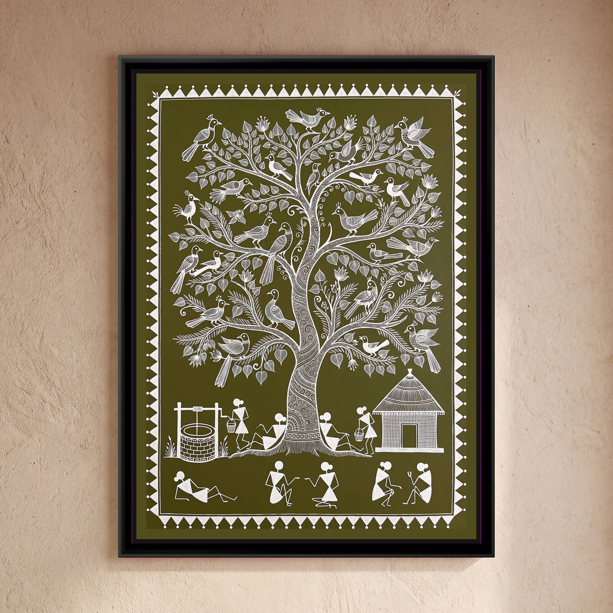 Warli Painting – Peepal Tree with Peacocks - framed canvas print of a tall Warli peepal tree with heart-shaped leaves and a spiral-patterned trunk, crested peacocks and birds perched across every branch, a brick well with a winch and a woman carrying a bucket on the left, a thatched hut and another woman with a basket on the right, villagers resting against the trunk and chatting in pairs along the bottom, white line on an olive green ground inside a border of white triangles and dots, hung on a wall