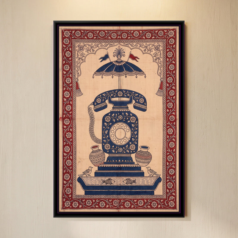 Kalamkari Painting – Rotary Telephone - framed canvas print of a vintage rotary telephone with a coiled cord, its body and handset covered in cream flowers on indigo, standing on stepped indigo plinths, a flagged parasol canopy and tassels above inside a scalloped arch, two pots, two birds and a pond with two fish below, deep red floral border, hung on a wall