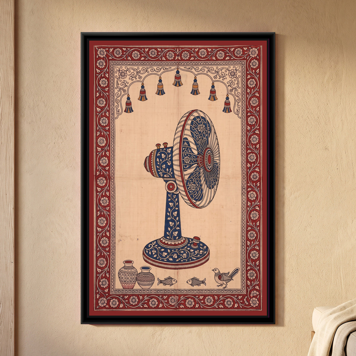 Kalamkari Painting – Table Fan - framed canvas print of a vintage table fan seen from the side, its stand, motor and blades covered in cream flowers on indigo, a row of hanging tassels in a scalloped arch above, two pots, two fish and a bird along the bottom, deep red floral border, hung on a wall