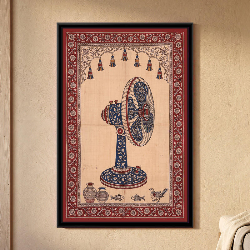 Kalamkari Painting – Table Fan - framed canvas print of a vintage table fan seen from the side, its stand, motor and blades covered in cream flowers on indigo, a row of hanging tassels in a scalloped arch above, two pots, two fish and a bird along the bottom, deep red floral border, hung on a wall
