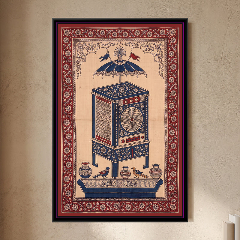 Kalamkari Painting – Desert Cooler - framed canvas print of a tall desert cooler on four legs with woven grass side panels, a round fan grille and red control knobs, covered in cream flowers on indigo, a fringed indigo parasol with two red and blue pennants above it, three patterned pots and two birds on a ledge, two fish in a water trough below, deep red floral border, hung on a wall