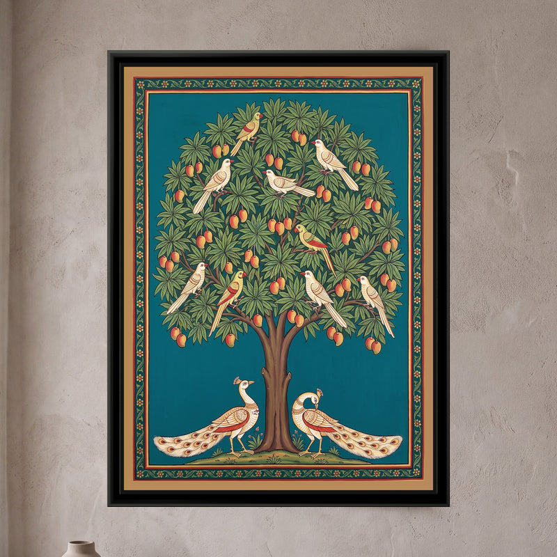 Pichwai Painting – Mango Tree in Fruit with Peacocks - framed canvas print of a tall mango tree with a round crown of green leaves and dozens of orange-red mangoes on a deep teal ground, seven white birds and three green parrots perched through the branches, two cream peacocks with long eyed tails standing on either side of the trunk on a small grassy mound, a narrow dark green border of tiny red flowers inside a flat tan band, hung on a wall