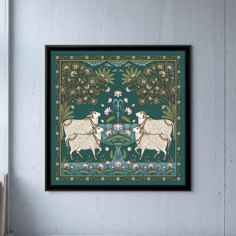Pichwai Painting – Cows around a Lotus Pond - framed canvas print of four white cows with fine gold scroll patterns on their coats, gold bells and tassels, two on each side facing a central fountain of pink lotuses and green lotus leaves rising from blue water, two flowering trees with pink blossoms arching in from the corners, banana leaves, curling blue clouds at the top, a strip of lotus pond along the bottom, a deep green ground with a border of small pink flowers on a vine, hung on a wall