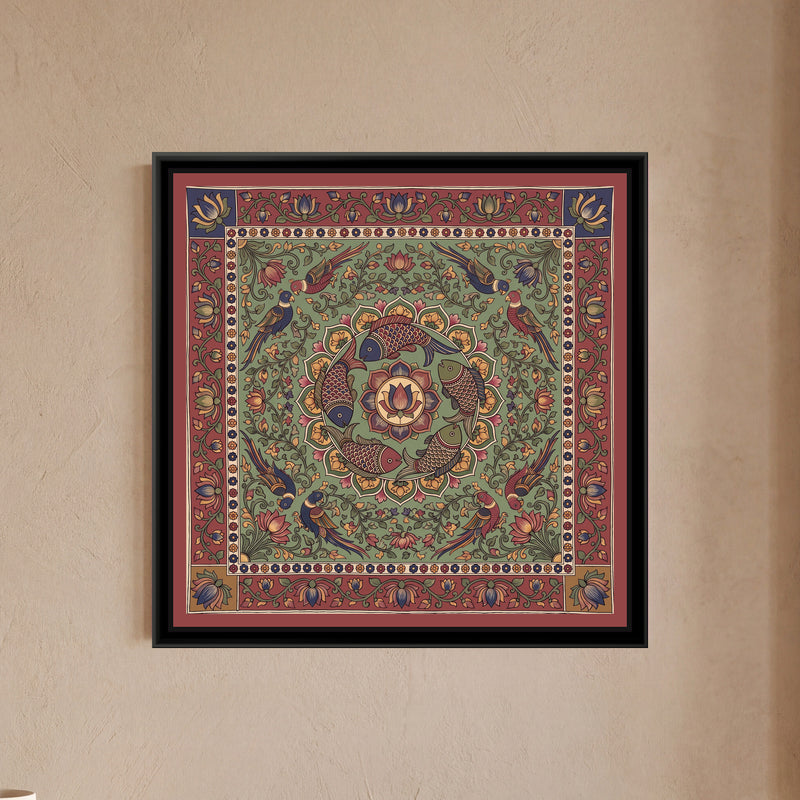 Kalamkari Painting – Fish Mandala – Sage Green - framed canvas print of five scaled fish in red, indigo and olive swimming in a ring around a central lotus medallion inside a circle of green and mustard petals, eight parrots in pairs among lotus vines, all on a sage green ground, a cream band of tiny flowers, an outer madder red border of lotus vines with indigo and mustard corner squares, a flat red outer edge, hung on a wall
