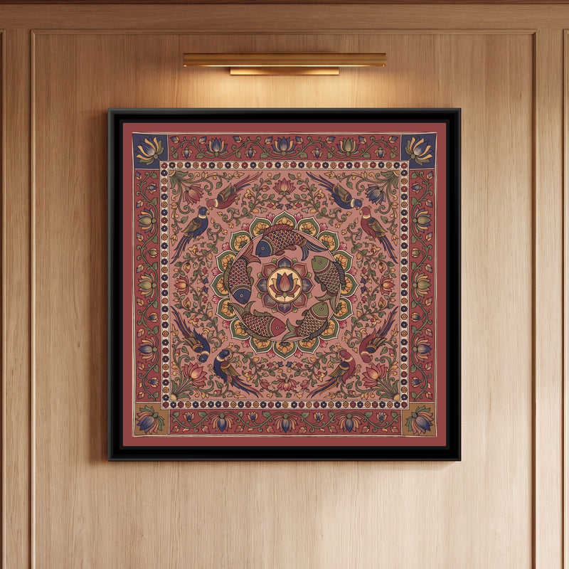 Kalamkari Painting – Fish Mandala – Dusty Rose - framed canvas print of five scaled fish in red, indigo and olive swimming in a ring around a central lotus medallion inside a circle of green and mustard petals, eight parrots in pairs among lotus vines, all on a dusty rose pink ground, a cream band of tiny flowers, an outer madder red border of lotus vines with indigo and mustard corner squares, hung on a wall