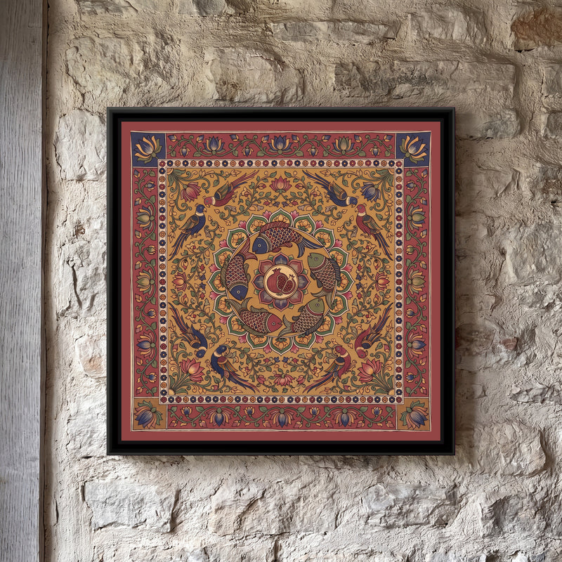 Kalamkari Painting – Fish and Pomegranate Mandala - framed canvas print of five scaled fish in red, indigo and olive swimming in a ring around a central medallion holding a split pomegranate full of seeds, inside a circle of green and mustard petals, eight parrots in pairs among lotus vines, all on a mustard ochre ground, a cream band of tiny flowers, an outer madder red border of lotus vines with indigo and mustard corner squares, hung on a wall