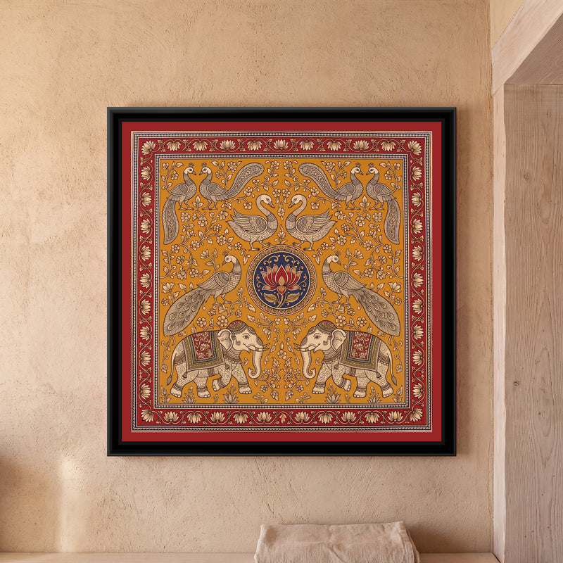 Kalamkari Painting – Elephant and Peacock Mandala - framed canvas print of two cream elephants in decorated red and green saddle cloths and caps facing each other at the bottom, a pair of peacocks with long sweeping tails above them, two swans facing each other at the top and peacock pairs in the upper corners, all around a round indigo medallion with a single red lotus, cream flowering creepers on a mustard ochre ground, inside a madder red border of cream lotuses on a trailing vine, hung on a wall