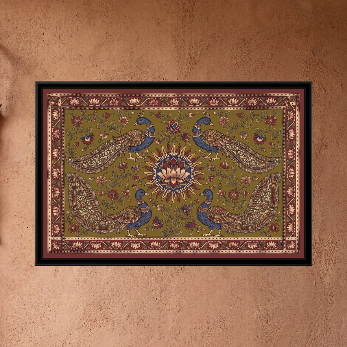 Kalamkari Painting – Four Peacocks around a Sun Medallion – Olive - framed canvas print of four indigo-bodied peacocks with long patterned tails, two above and two below, turned towards a central red-rayed sun holding a cream lotus on an indigo disc, flowering creepers on a deep olive green ground, inside a madder red border of cream lotuses on a running vine and a flat maroon outer band, hung on a wall