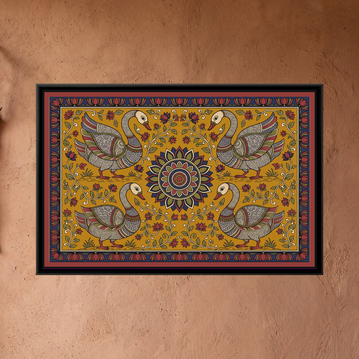 Kalamkari Painting – Four Swans around a Sun Medallion - framed canvas print of four cream swans with finely patterned indigo, red and olive wings standing on little grassy banks, two above and two below, facing a central many-petalled medallion in indigo, olive and red, cream creepers with red flowers on a mustard yellow ground, inside an indigo border of red lotus buds and a flat red outer band, hung on a wall